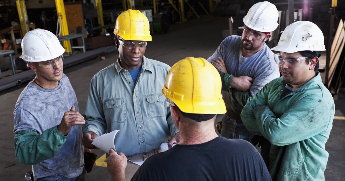 Multi-ethnic workers in fabrication shop